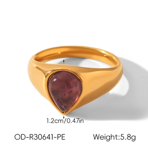 Detailed macro view of pear-cut purple stone gold ring with size and weight info