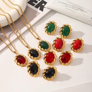 French vintage gold necklaces and stud earrings with emerald and red oval gemstones