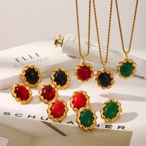 French vintage jewelry set with oval emerald, ruby, and onyx pendants and matching earrings