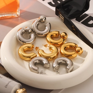 Polished thick C-shaped hoop earrings in gold and silver finish for a minimalist look