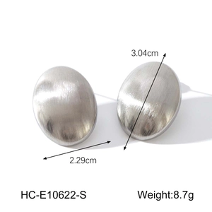 Detail view of oval stainless steel earrings with brushed silver texture and dimensions