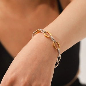 Two-tone 18K gold and silver stainless steel chain bracelet with hammered texture on wrist