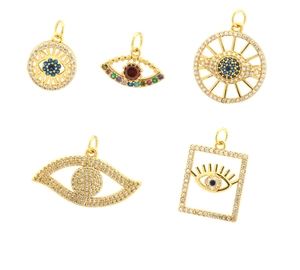 Detailed close-up of diverse gold-plated evil eye charms with colorful zircon inlays
