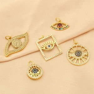 Detailed view of evil eye charms in gold-plated copper with colorful zircon stones