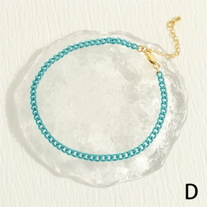 Detail of turquoise hip-hop anklet with gold lobster clasp and teardrop extension chain