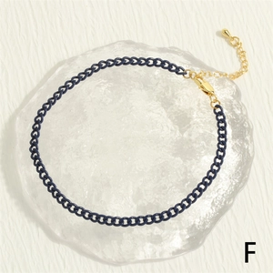 Detail view of navy blue matte Cuban link anklet with gold lobster clasp and extension chain