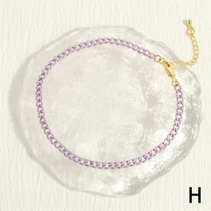Detail of purple Cuban link anklet featuring a gold lobster clasp and extension chain