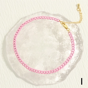 Detailed view of pink curb chain anklet with golden lobster clasp and adjustable drop charm