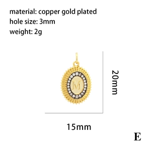Detail of gold-plated brass pendant with M initial and micro-set stones in sunburst design