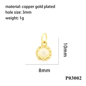Detailed macro view of 18K gold plated oval pendant with white bead for jewelry making