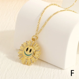 Detail of 18K gold sunflower smile pendant with pavé zircons on Figaro chain