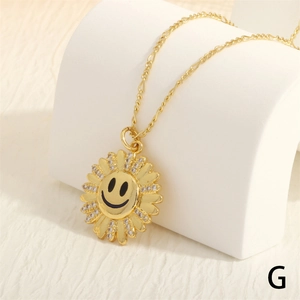 Close-up of gold sunflower smiley face pendant with micro-pave zircons on a delicate chain