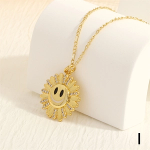 Detailed macro view of 18K gold-plated sun flower pendant with zircon and smiley face