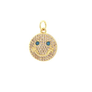 Detalle macro del colgante de sonrisa en oro de 18K con circones y ojos turquesas