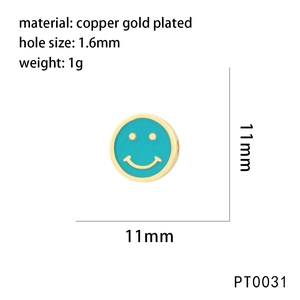 Macro detail of 11mm brass gold plated bead with cyan enamel smiley face design
