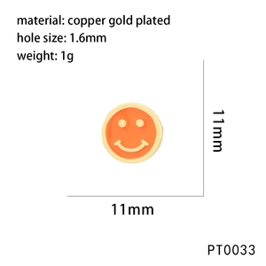Macro detail of copper gold plated orange enamel smiley face charm with 1.6mm hole