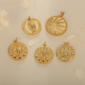 Gold religious medallions with colorful zircons and intricate relief on cream background