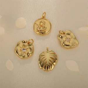 Set of four gold-plated religious pendants with angel relief and starburst zircon crystals