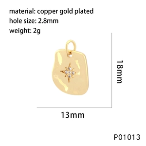 Detail of 18k gold plated shield pendant with star engraving and cubic zirconia stones