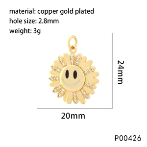 Detailed close-up of a gold-plated sunflower smiley pendant with white sparkling rhinestones