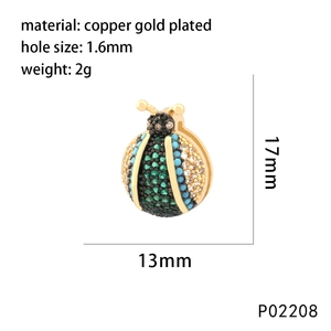 Golden ladybug pendant in copper gold plating with vibrant green and blue cubic zirconia