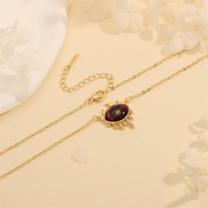 Detail view of gold Evil Eye necklace with starry stone pendant and zircon inlay