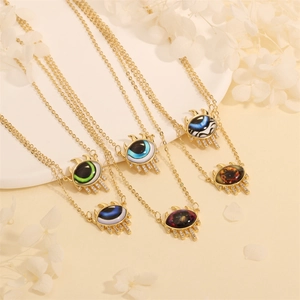 Detail of diverse evil eye triangle pendants with gold plating and sparkling crystals