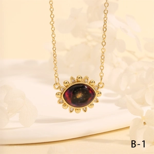 Macro shot of vintage Turkish eye pendant with deep red stone and gold plating detail