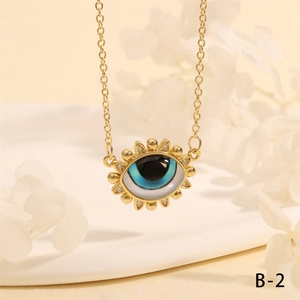 Macro shot of gold Turkish evil eye pendant necklace with blue enamel and crystal inlay