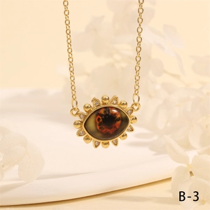 Detailed shot of evil eye pendant with sunburst frame and zircon inlays on gold chain