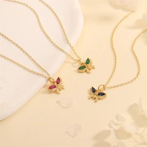 Detailed close-up of 18K gold plated butterfly necklaces with red, green and blue zircon