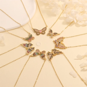 Detalle de collares de mariposa con circonitas de colores y baño de oro