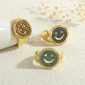 Anillos de sonrisa dorados con micro pavé de circonitas en azul, verde y marrón