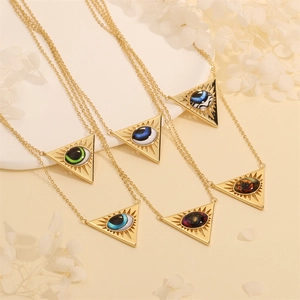 Detailed macro view of six gold triangular Evil Eye pendants with various iris colors