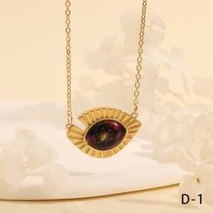 Detailed close-up of golden evil eye triangle pendant necklace on minimalist chain