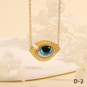 Close-up of golden Turkish evil eye necklace with blue pendant on elegant beige background
