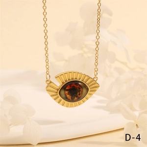 Close-up of gold Turkish evil eye necklace with red center and sunburst metal rays