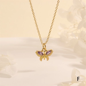 Close-up of 18K gold plated butterfly pendant with purple marquise zircon and beads