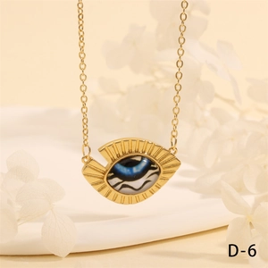 Detailed view of the gold Evil Eye triangle pendant necklace with blue pupil and wavy pattern