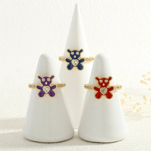 Detail of colorful teddy bear rings with inlaid heart zircons and gold plating