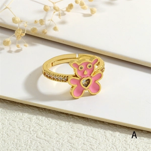 Detail of gold-plated bear ring with pink enamel and sparkling heart zircon stone