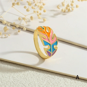 Detail of colorful enamel leaf ring with golden band and artistic feather design