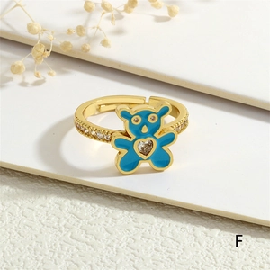 Detail of gold-plated open ring with blue enamel bear and heart-shaped zircon stone