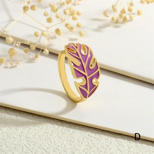 Detail of gold-plated open leaf ring with purple enamel monstera leaf design