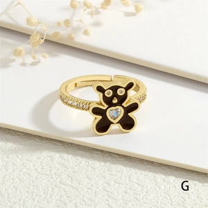 Detail view of gold bear ring with black enamel, heart zircon and adjustable band