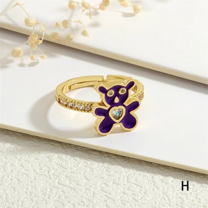 Close-up of purple enamel teddy bear ring with heart zircon and crystal pavé band