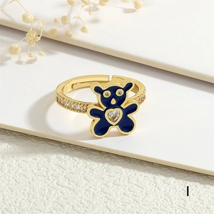 Macro shot of gold-plated bear ring with blue enamel and heart-shaped cubic zirconia detail