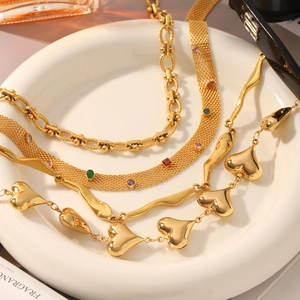 Detail view of 18k gold-plated necklaces with colored gemstones and heart pendants