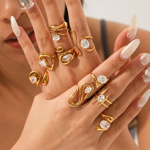 Detail of gold-plated geometric stacking rings with sparkling cubic zirconia on model hand