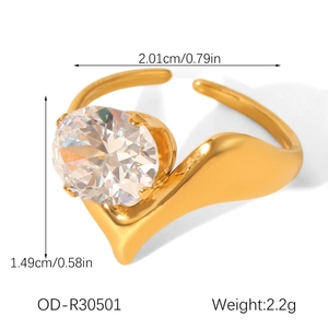 Detailed view of an adjustable gold ring featuring a large oval zircon and wavy band